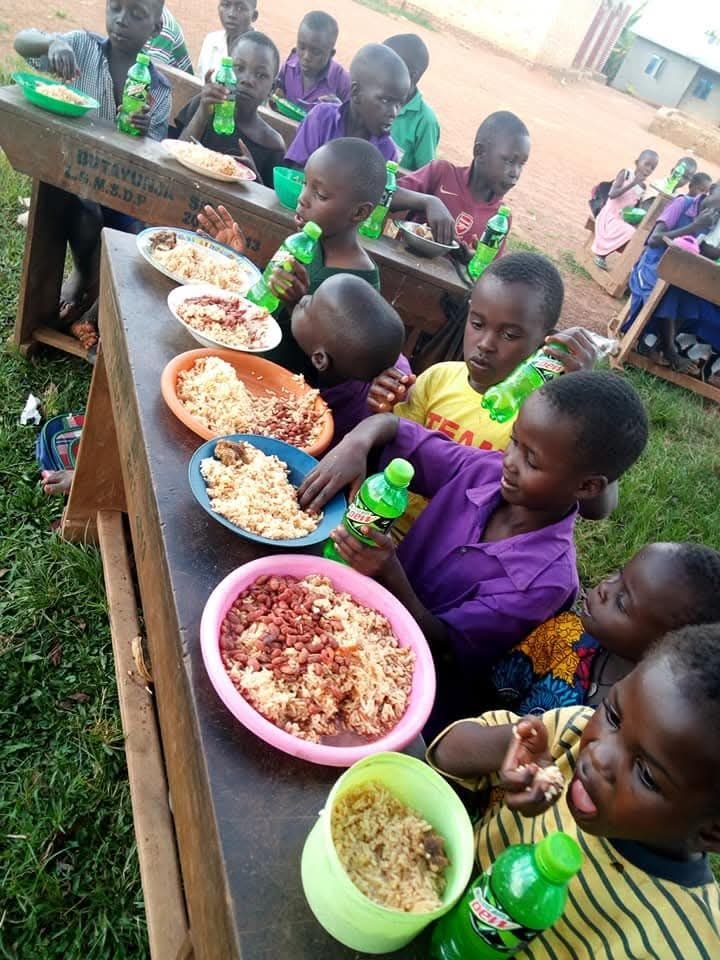 Community event where people receive donated clothing in Uganda